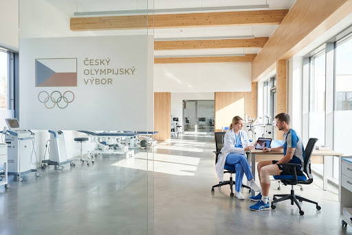 Modern sports medical facility with Czech Olympic Committee logo.
